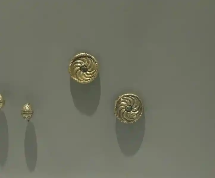 Gold buckles with image of Borjgali, Gregorian swastika